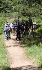 Children with snowshoes on hiking through the preserve as part of a program.